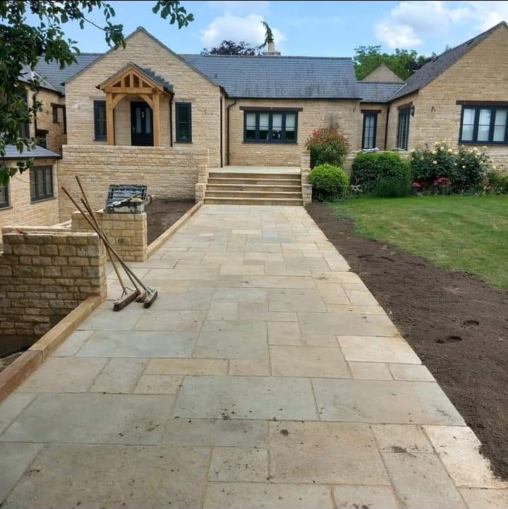 Stone bungalow with porch and sandstone path