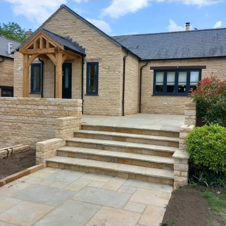 Stone front porch with stepped sandstone patio